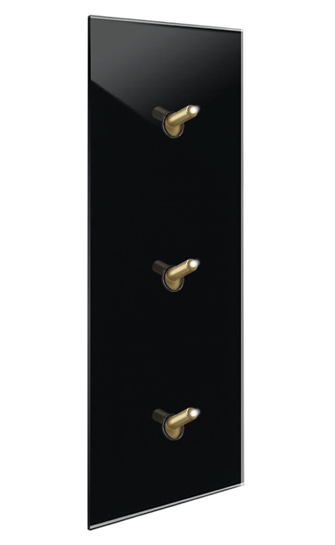 Modern illuminated design light switch in black glass optic with 3 brass toggle levers. YORK